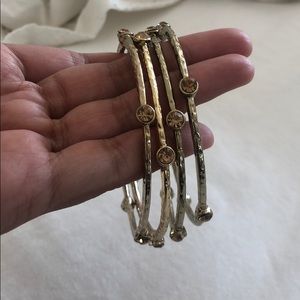 Gold tone bangles with beige crystals